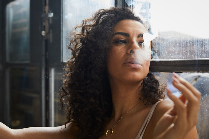 Woman smoking by window
